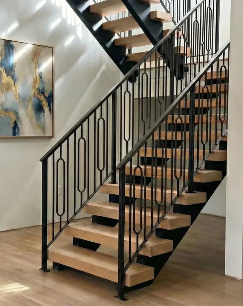 Custom interior floating stairs with wood treads and decorative metal railings in a Seattle home