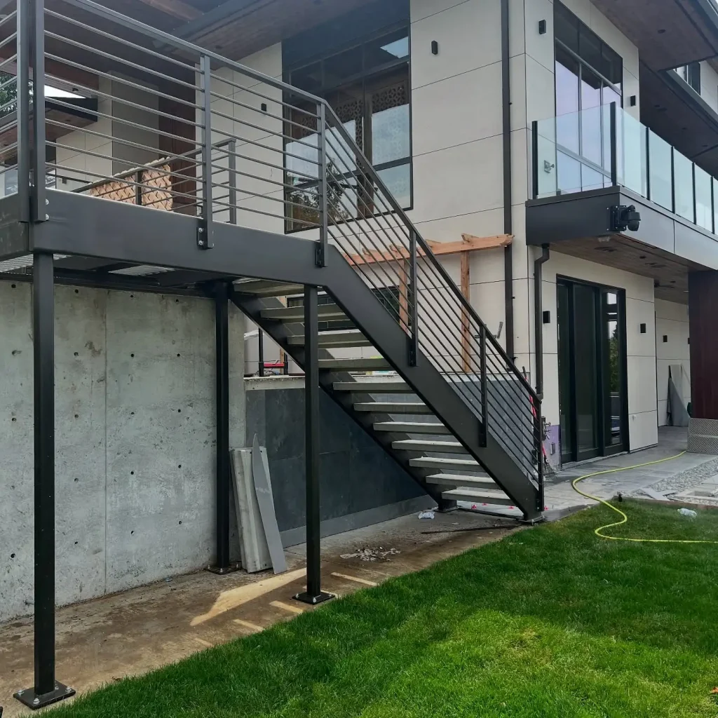 Custom exterior double stringer stairs with horizontal bar railings and concrete treads in Seattle, WA